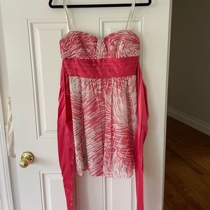 BCBGMaxazria coral, beige and silver strapless cocktail dress with bow in back.